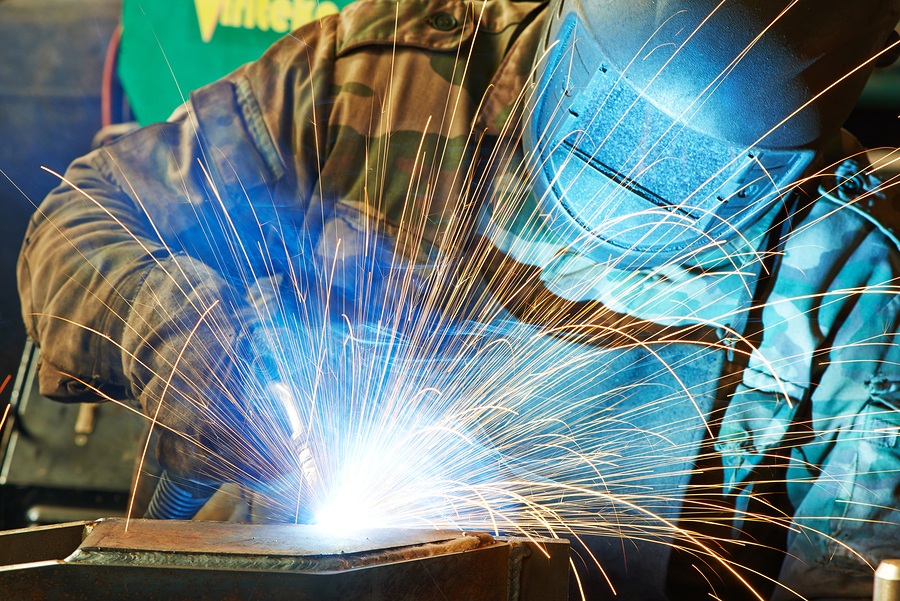 Welder working with electrode semiautomatic arc welding