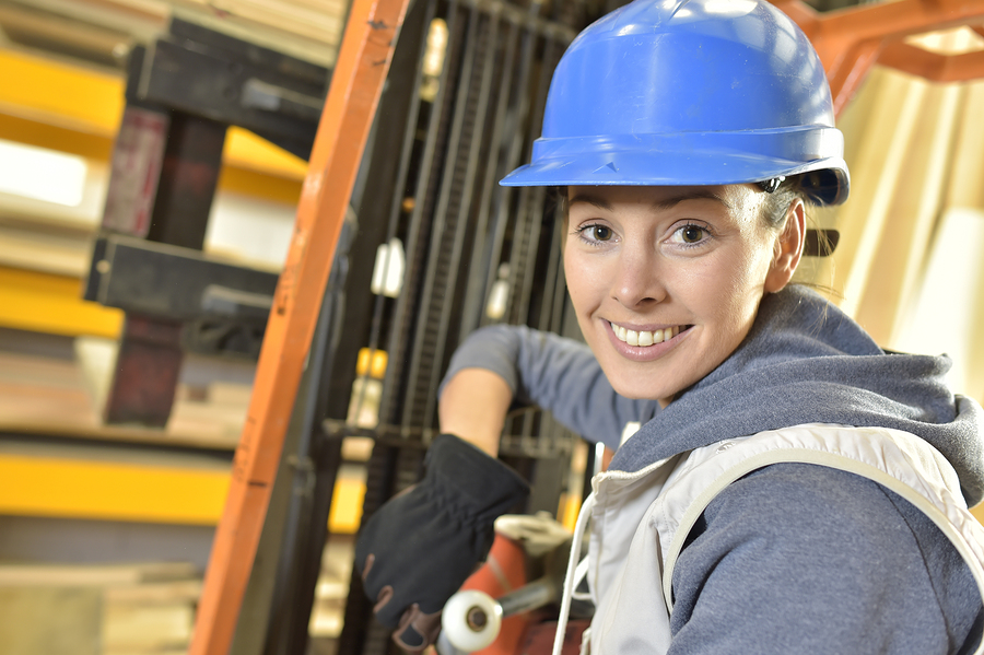 Female factory technician using forklift