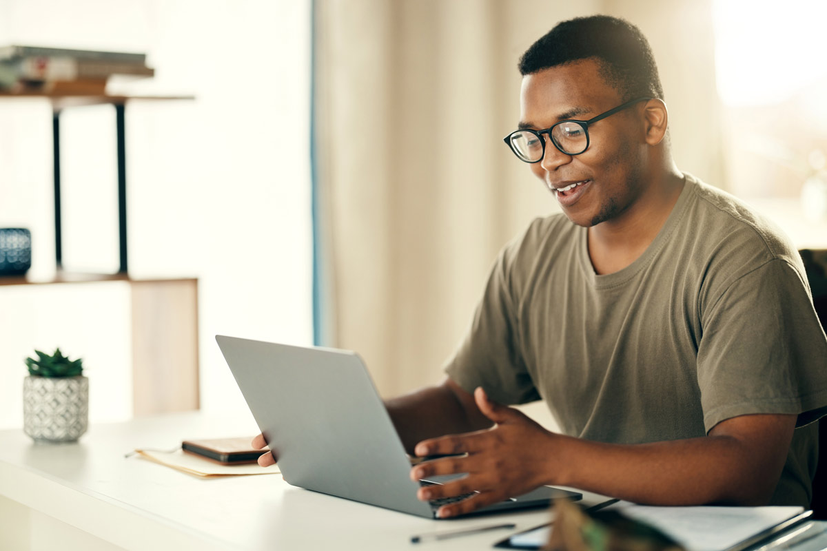 Man studying H2S awareness training on a laptop at home