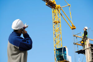 Man performing hand signals for crane for Rigging Certification Training 